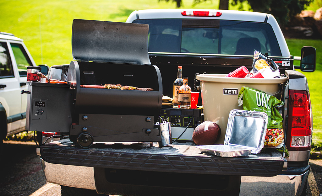 The back of a pickup truck packed with tailgating equipment.