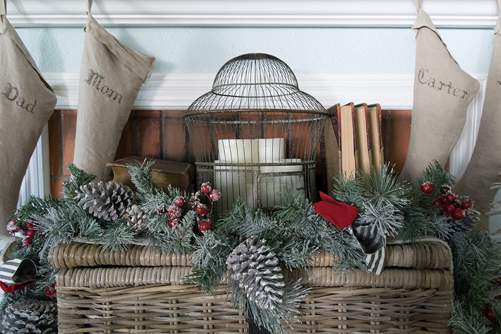 Holiday stockings, candles and garland mantel decor Holiday stockings, candles and garland mantel decor