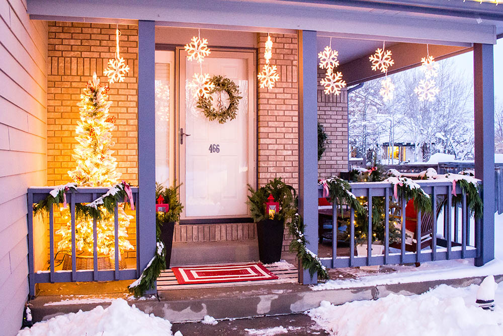 A front porch with Christmas lights on