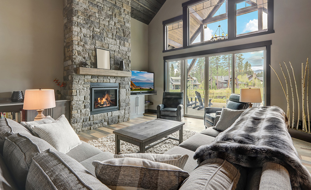A wood-burning, stone fireplace in a contemporary living room.