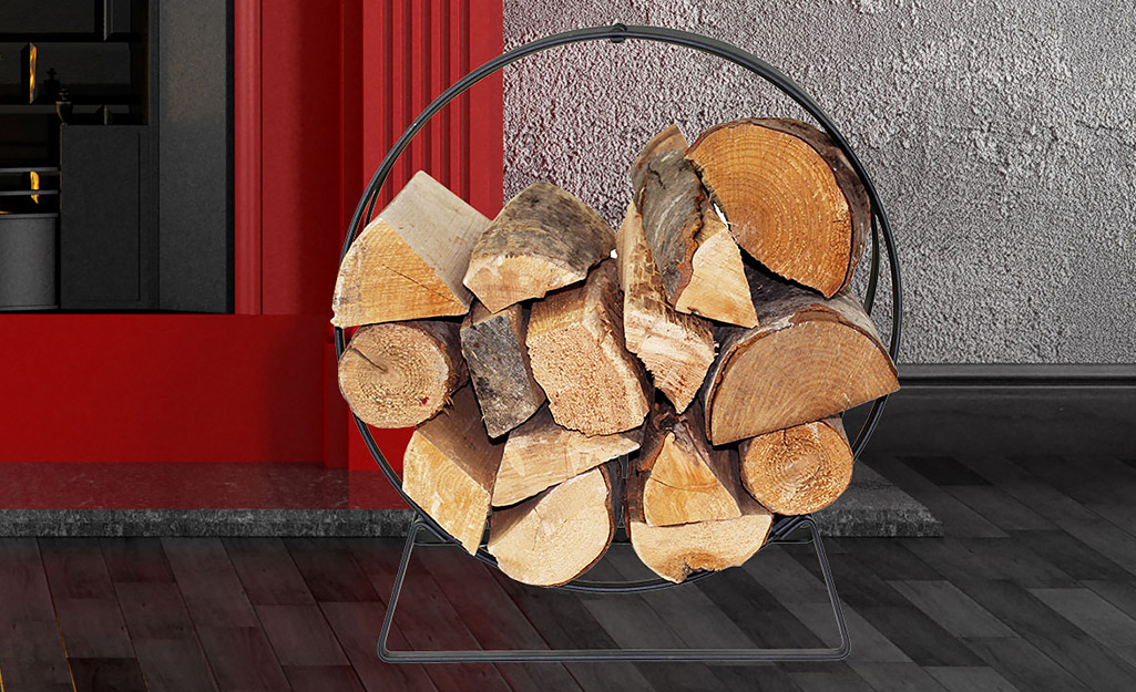 Pieces of firewood stacked in a firewood rack beside a door.