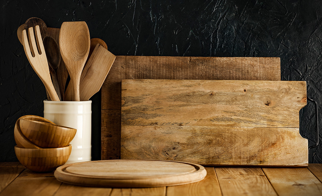 A selection of wood kitchen utensils sit on a counter.