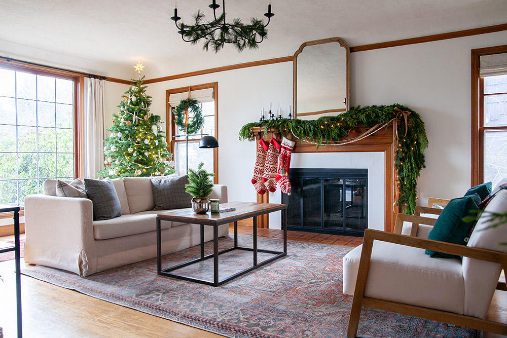 Living room with Christmas tree and greenery decorations