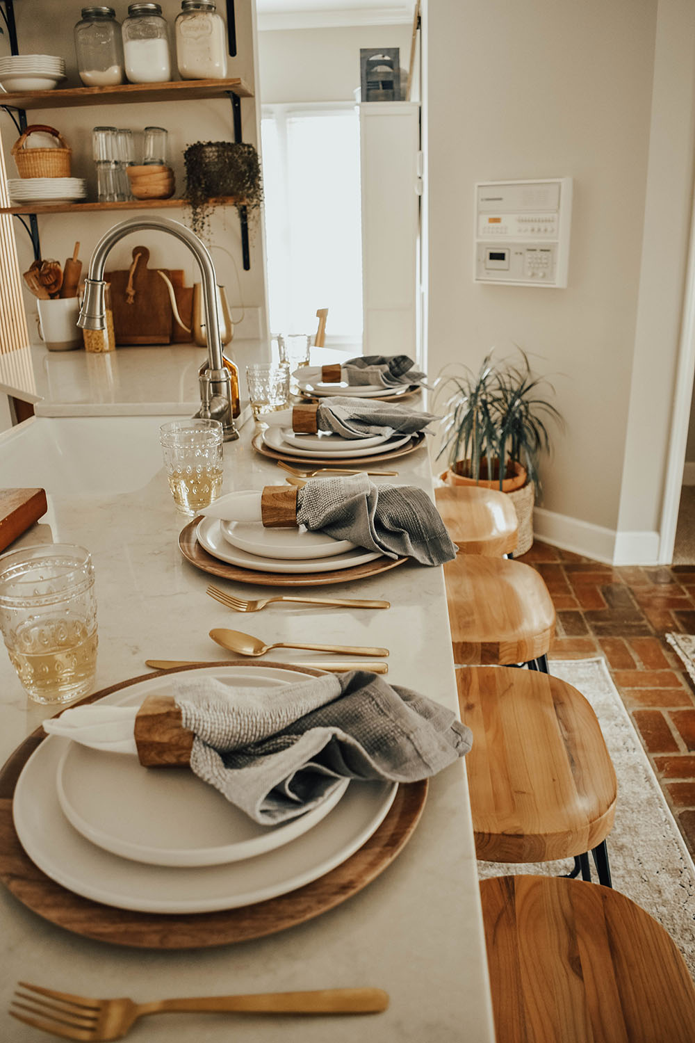 A kitchen island with place settings for a Friendsgiving dinner.