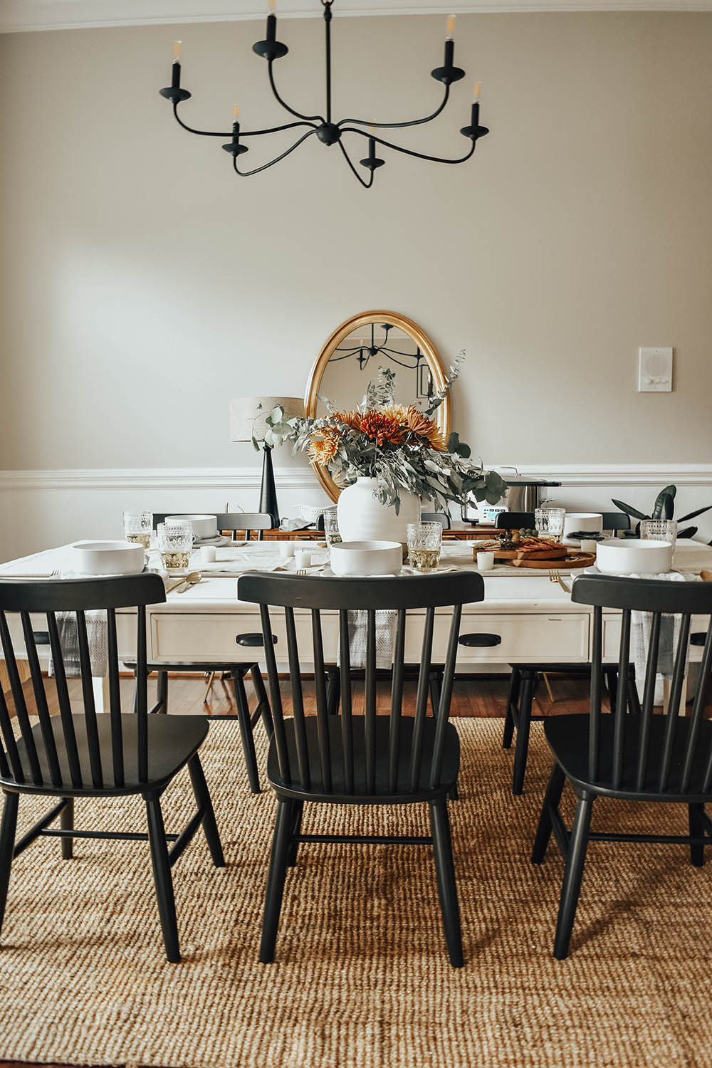 A large wooden table with black wooden chairs.