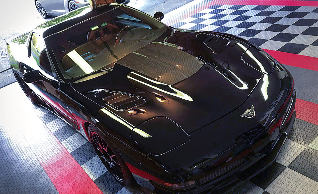 Interlocking tiles on a garage floor include bright colors as well as black and gray.