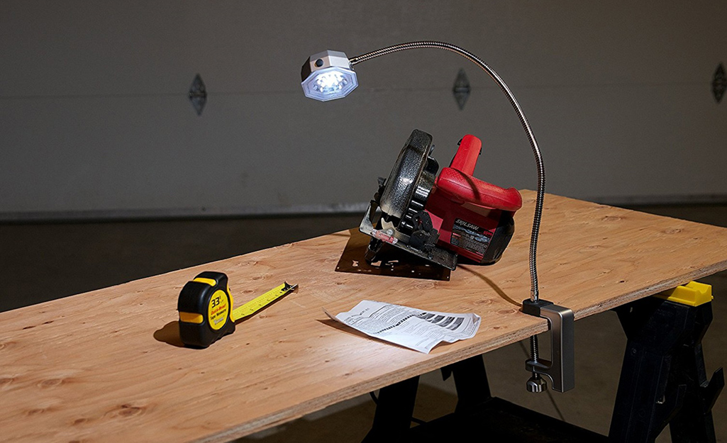 A work bench provides a surface for a tape measure and a circular saw.