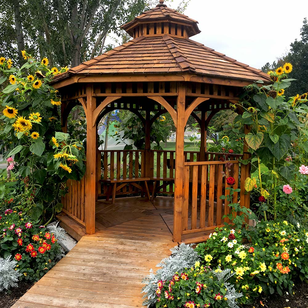 A wood gazebo in a garden.