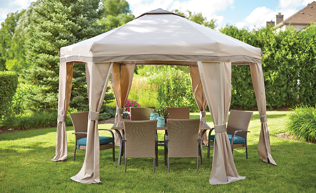 A gazebo with a tan fabric covering.