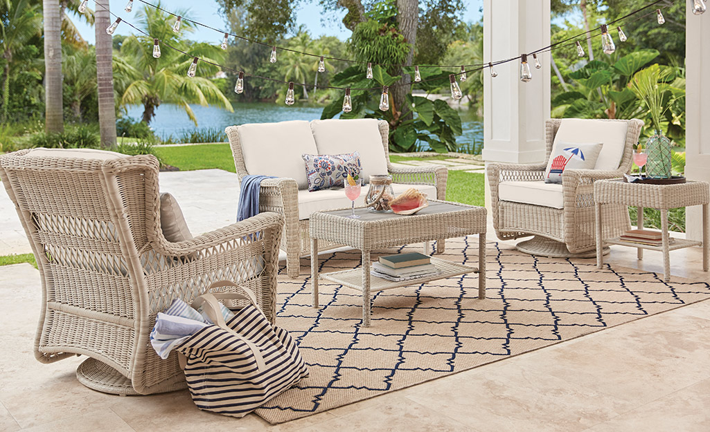 A patio set atop an outdoor rug.