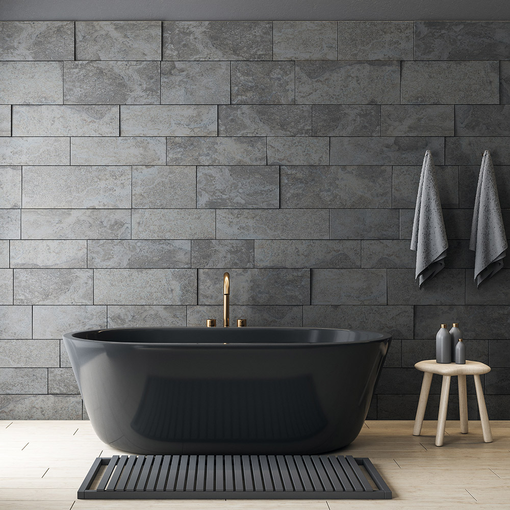 Black and gray bathroom design with black bathtub and gray stone walls.  