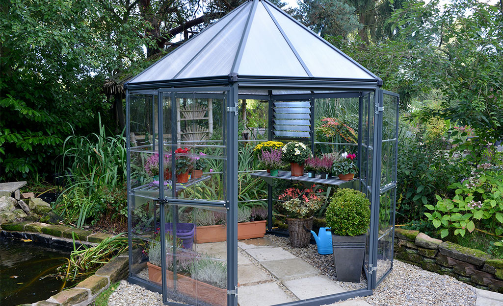 A hexagon shaped greenhouse of glass panels. 