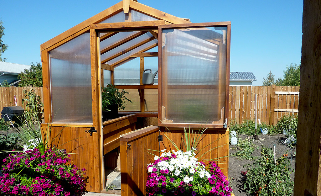 A greenhouse with a wood frame. 