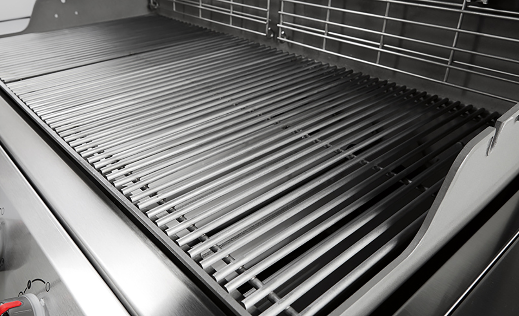 An open grill with clean grill grates.