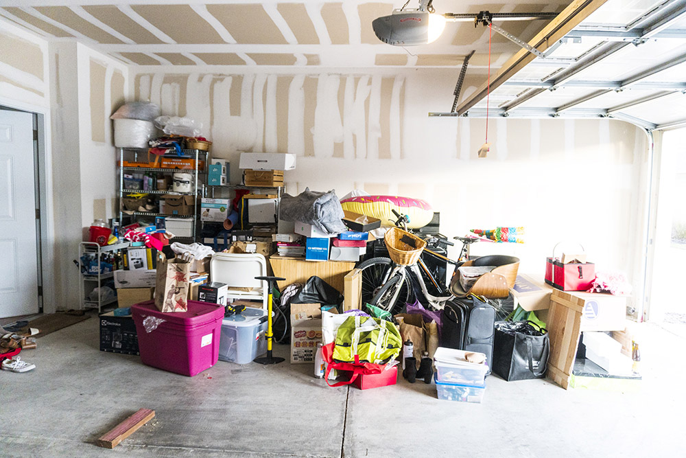 Open garage with items on the floor before organization