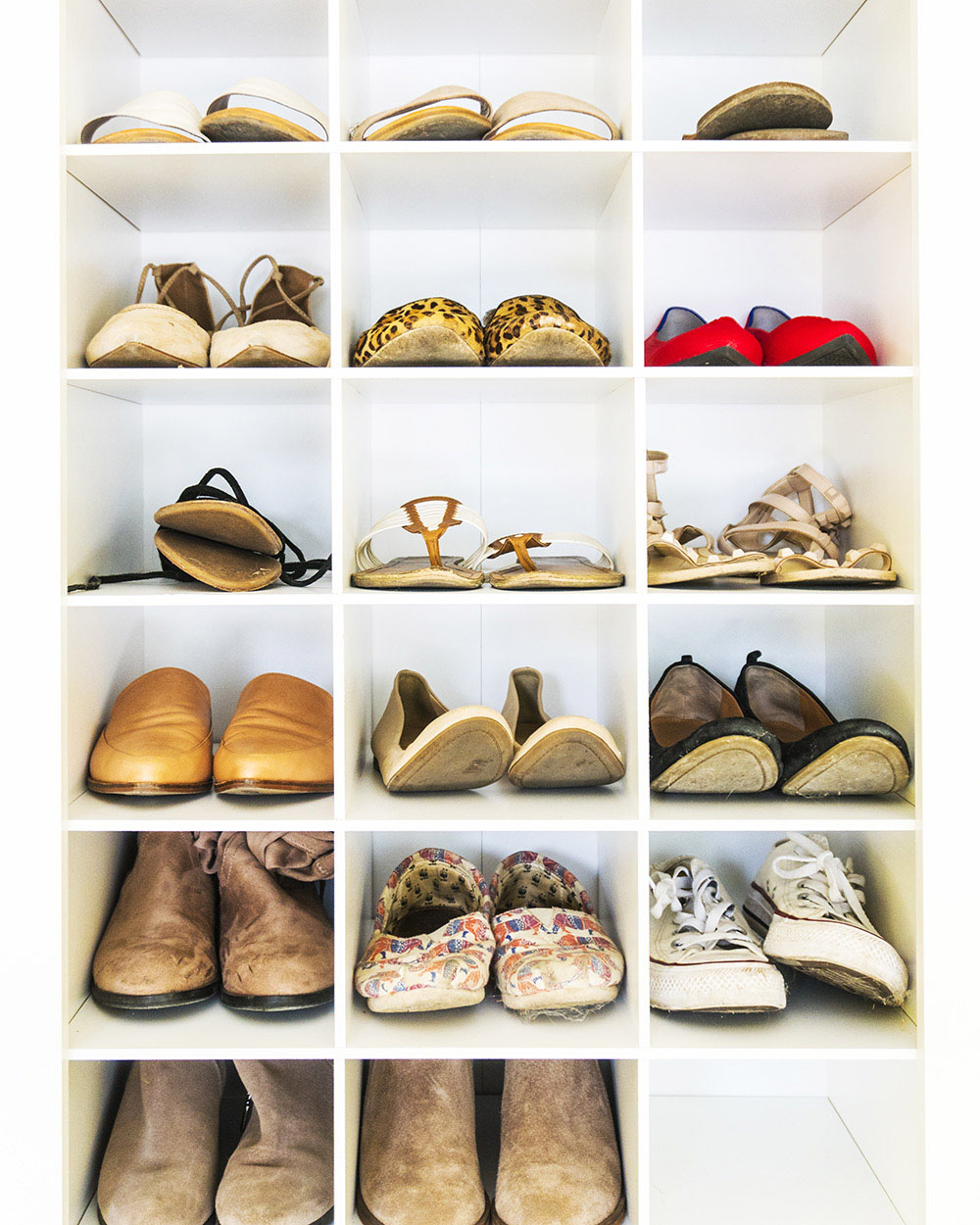 Shoes organized in wall shelves 