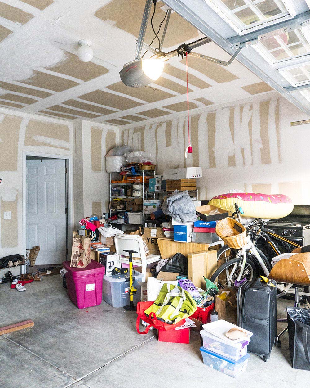 A garage with items on the floor prior to organization