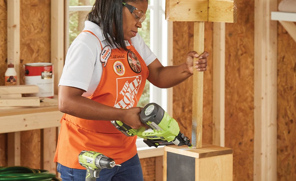A woman attaches all the pieces together to complete her project. A woman attaches all the pieces together to complete her project.