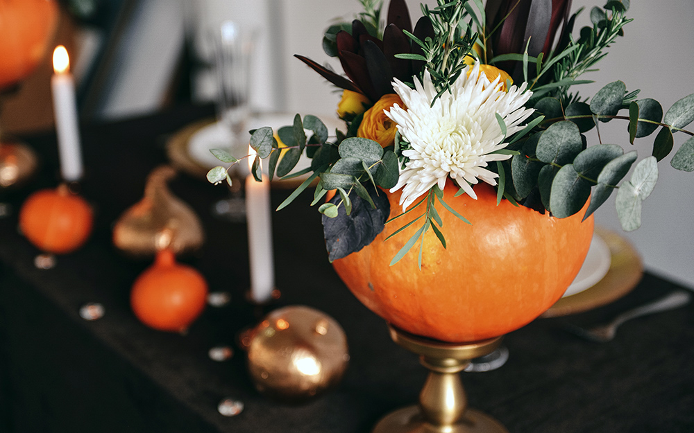 A floral arrangement in a pumpkin.