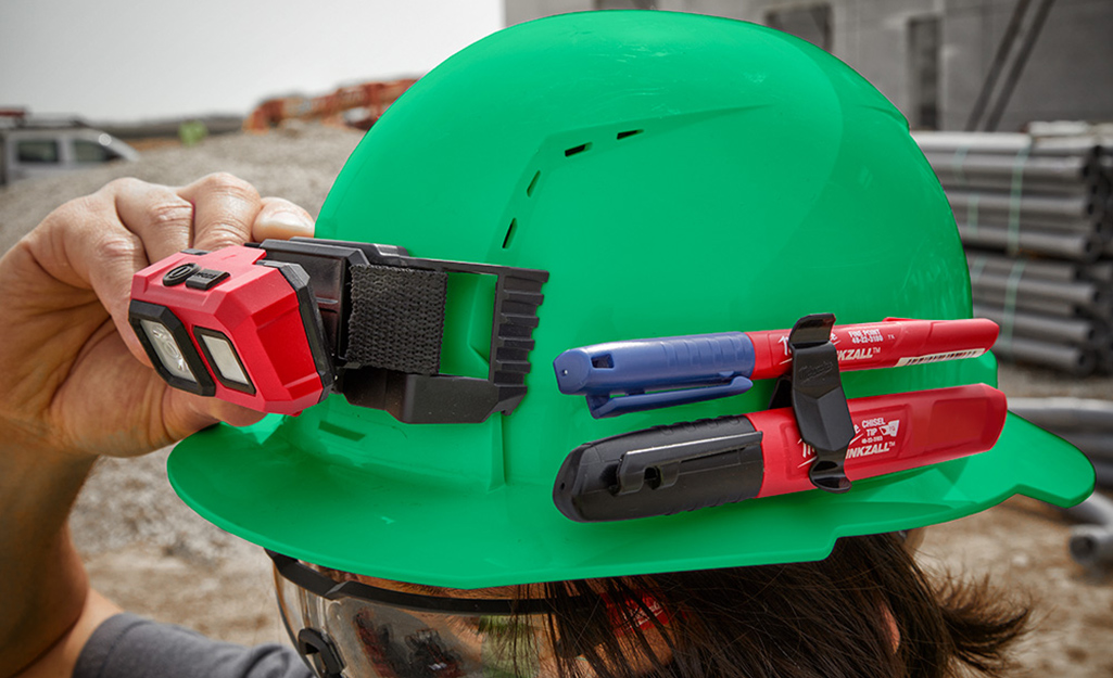 A person with a green hard hat