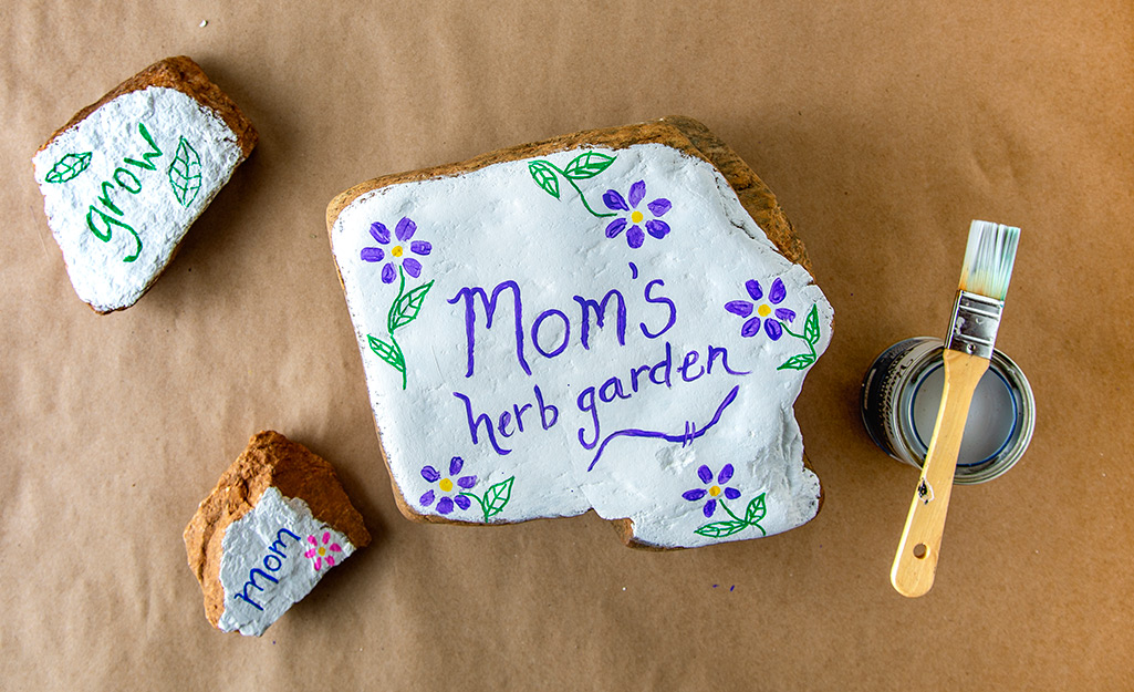 Painted rocks with a can of polyurethane next to them.