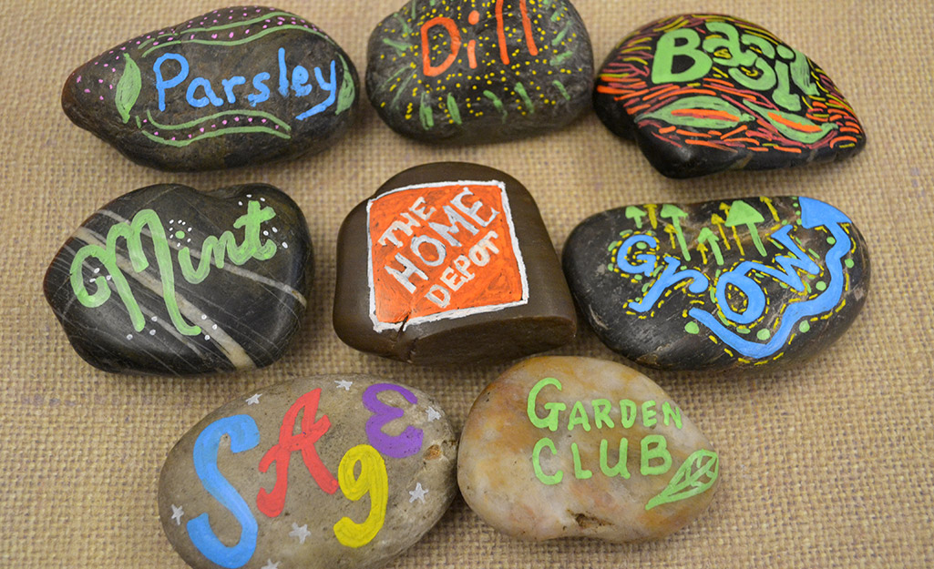 Rocks with painter herb names on a table.