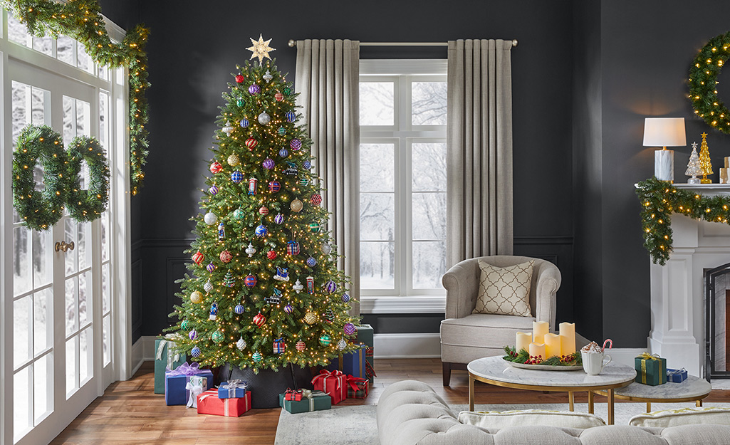 A Christmas tree with presents underneath in a holiday living room