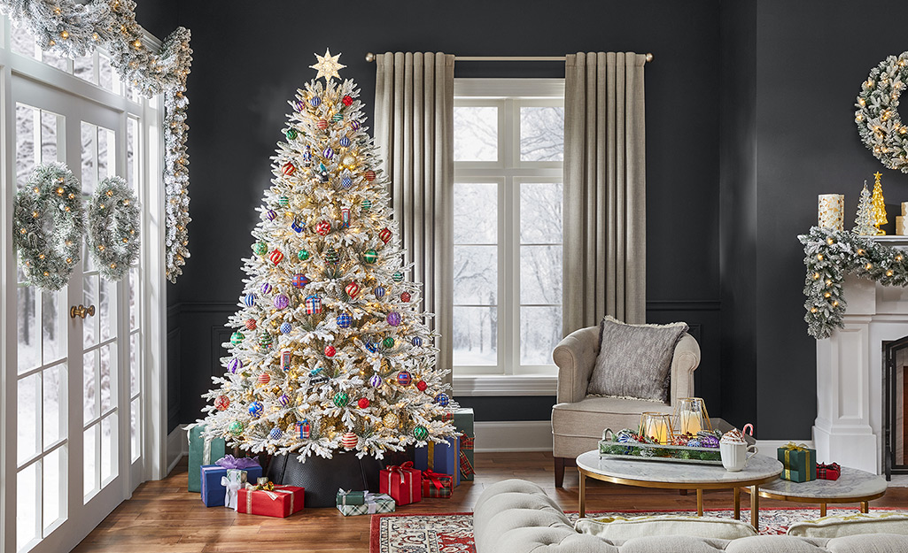 A white decorated Christmas tree in a holiday living room