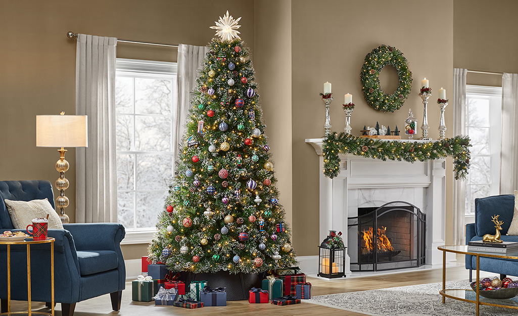 A Christmas tree decorated in red, green and gold in a living room