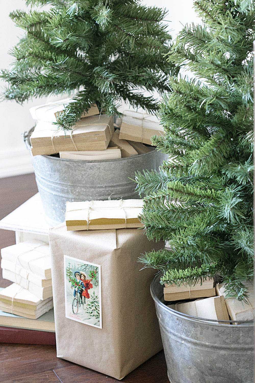 Two small Christmas trees in tin buckets 