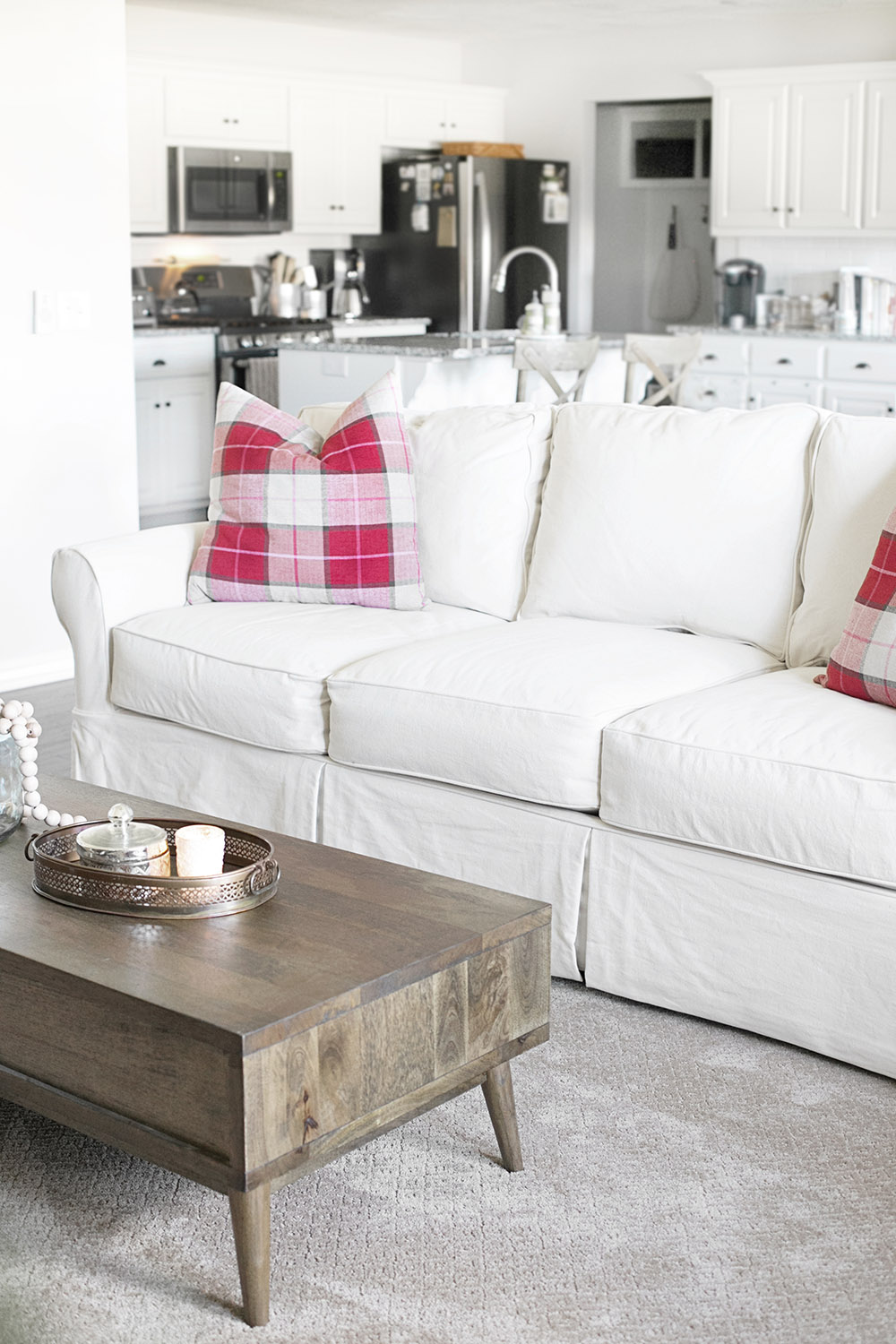A living room with a white couch and coffee table