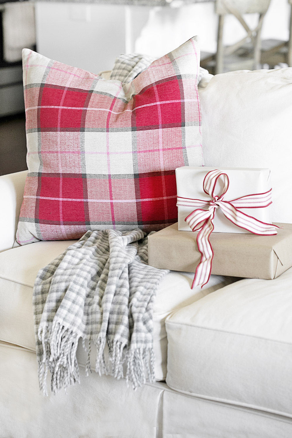 Blanket, boxes and pillow sitting on couch 