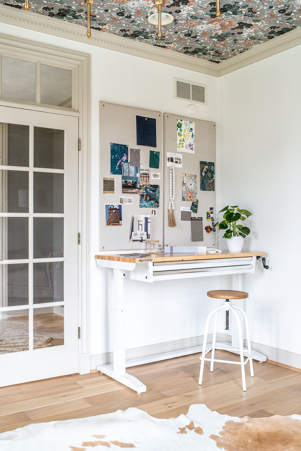 An office corner with a white adjustable height Husky workbench.
