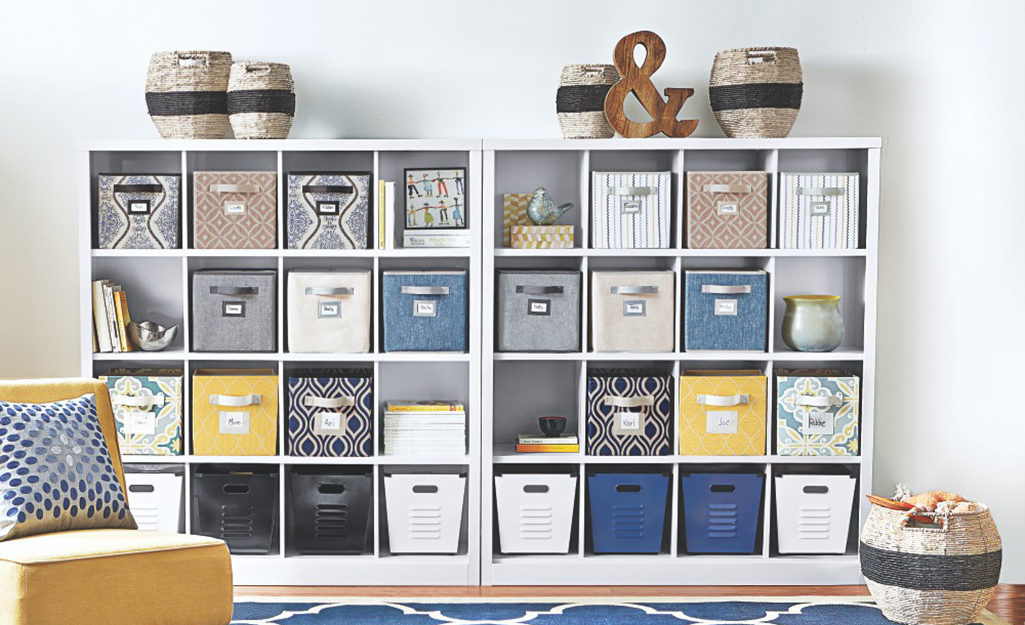 A home organization unit with cubbies holds a variety of bins.