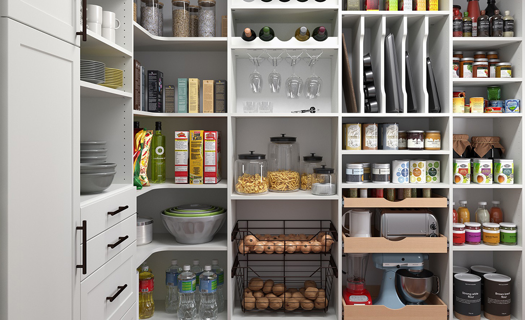 Food is organized on shelves and in bins and drawers in a custom pantry.