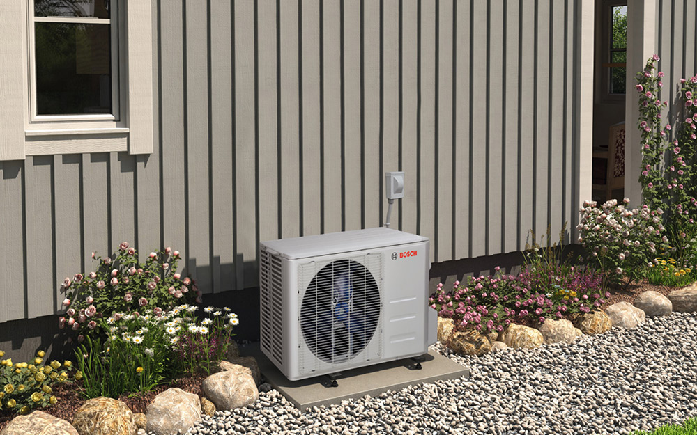 An air conditioning condenser unit outside a home.