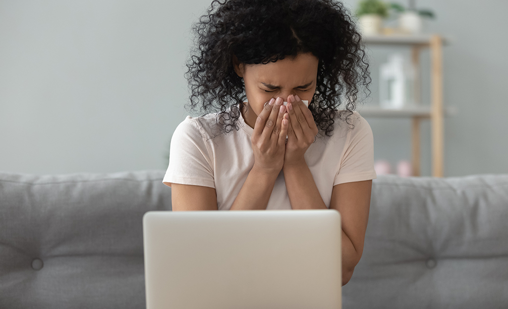 A woman sneezing.