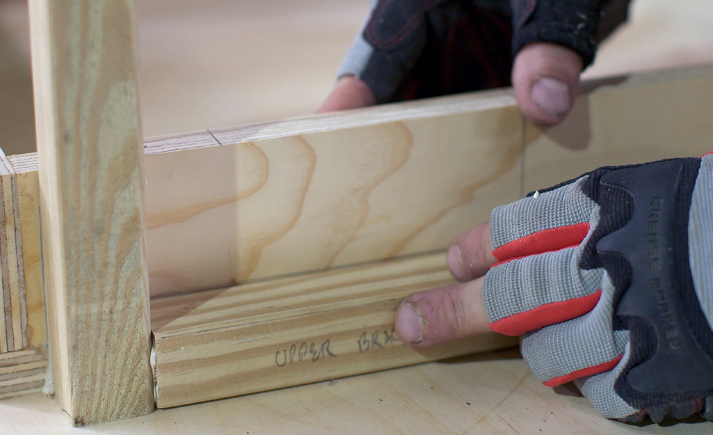 Piece of plywood being attached to the DIY desk Piece of plywood being attached to the DIY desk
