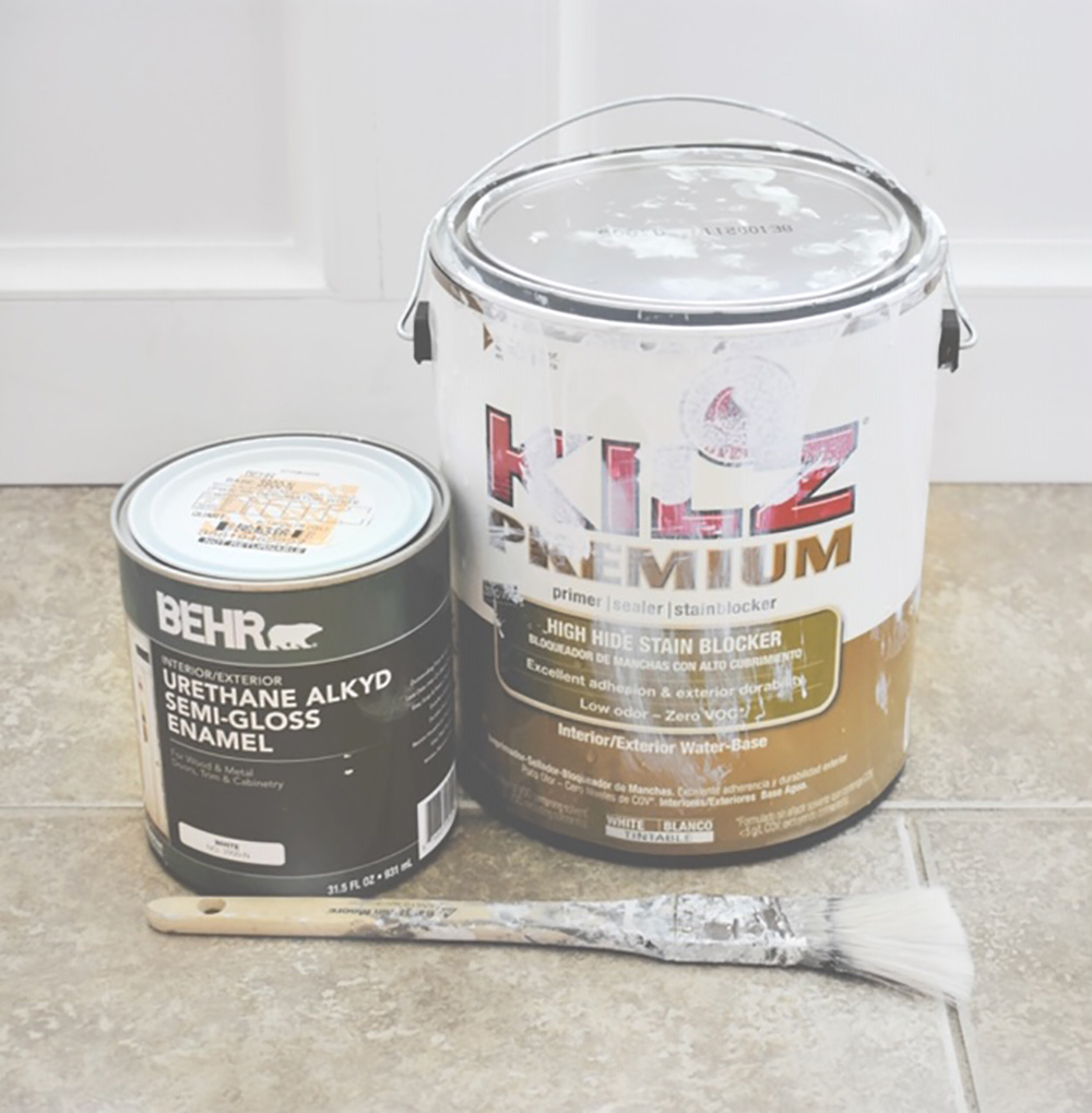 A can of Kilz primer, a can of Behr urethane alkyd semi-gloss paint, and a paint brush.