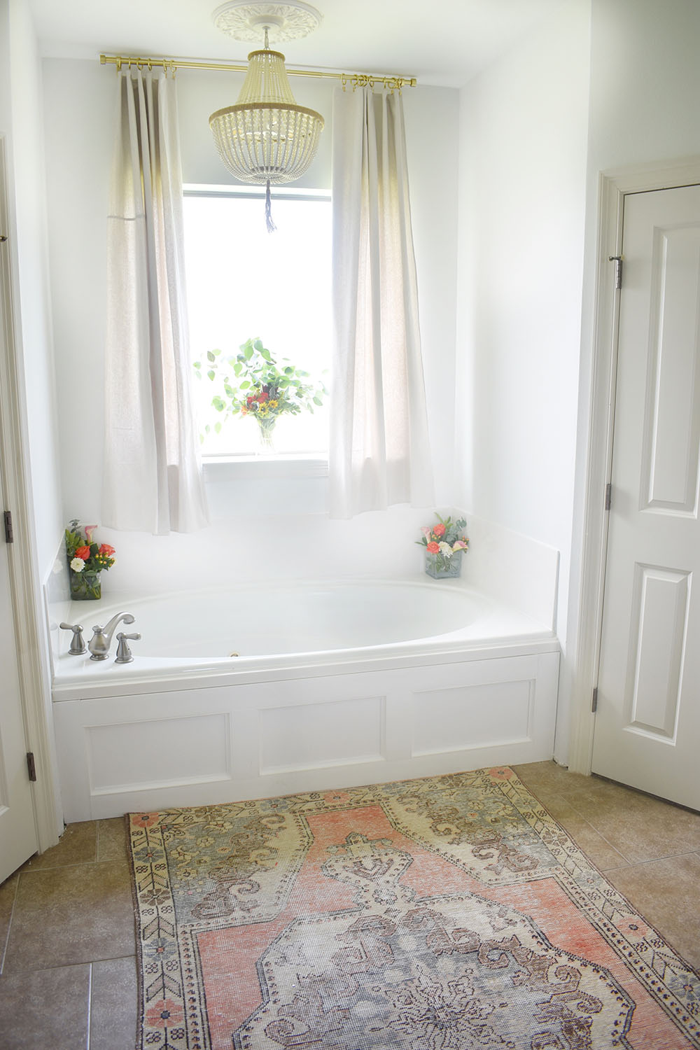 An bathtub updated with white decorative moulding.