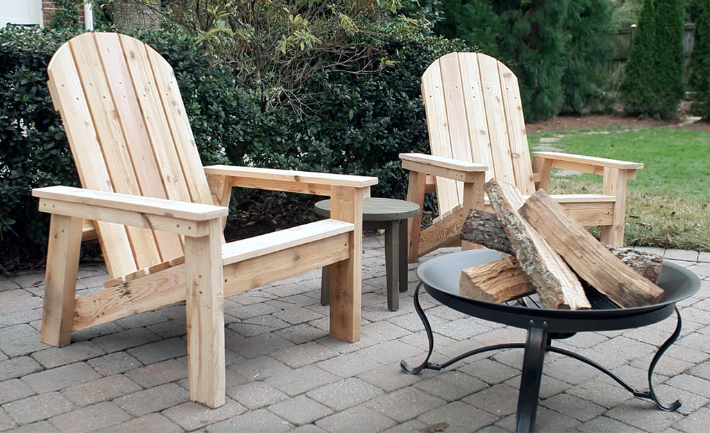Two DIY Adirondack chairs outside near a fire pit.