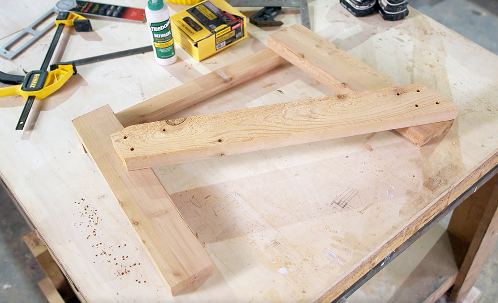 The stringer board attached to the legs of an Adirondack chair.