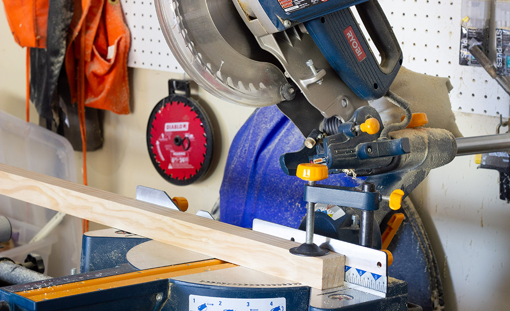 A saw cutting a piece of wood. A saw cutting a piece of wood.