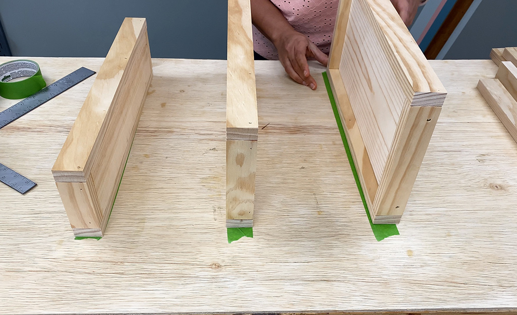 Three pieces of wood standing on a table.