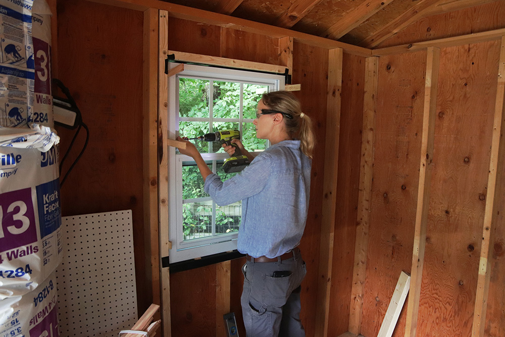 A person installing a window 