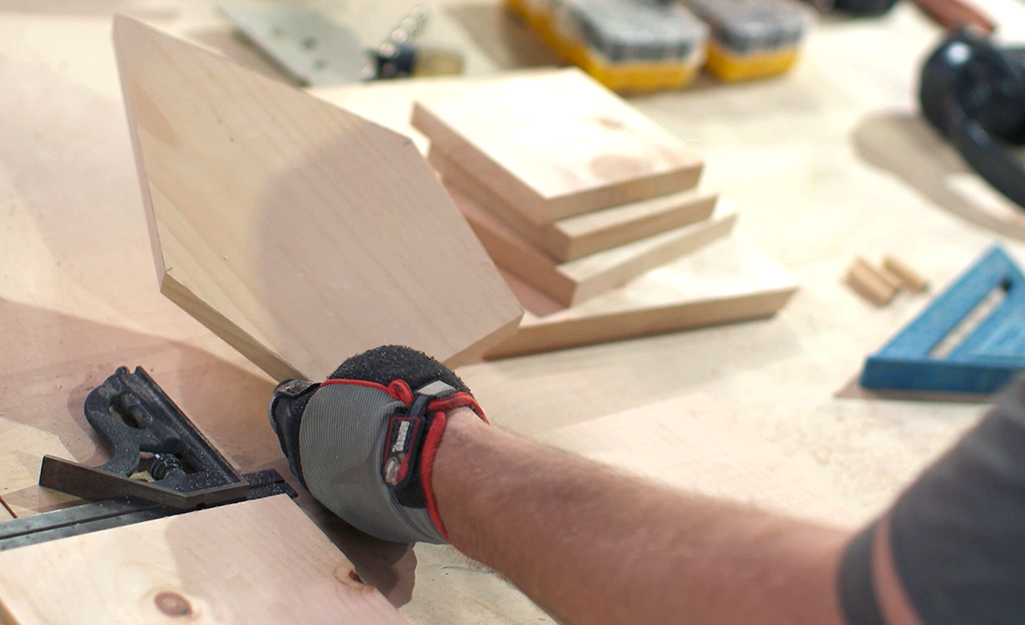 A wood panel being trimmed.