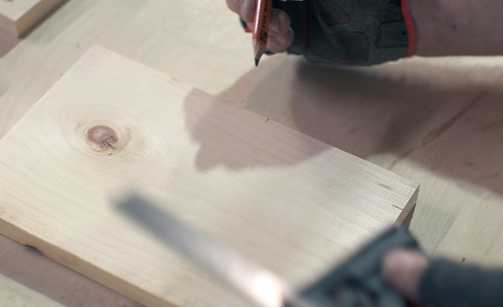 A piece of wood being measured and marked.