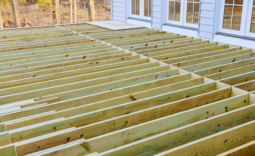 Lumber laid out to form a deck.