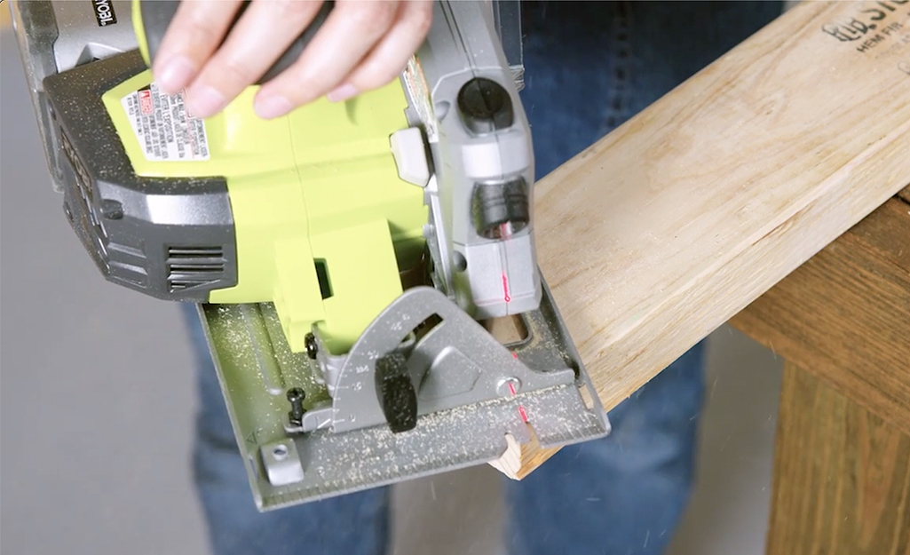 A close-up image of a saw making angled cuts to a stud.