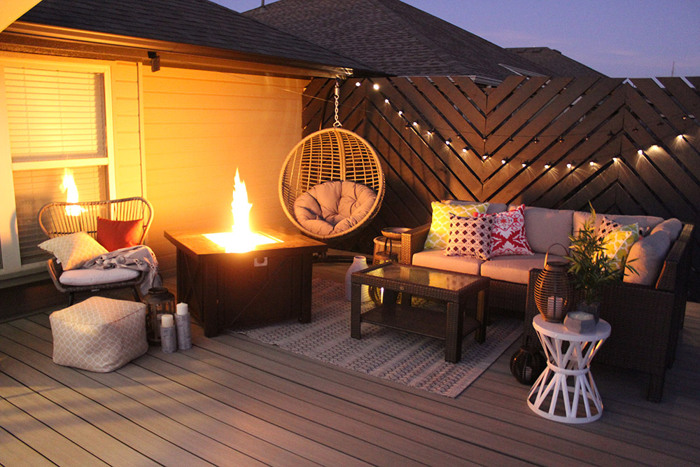 Patio furniture and outdoor decor on floating deck at night